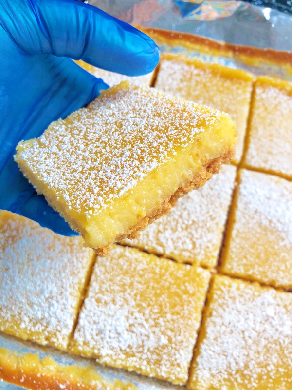 SWEET BITES MENU: shown is a batch of our Lemon Bars which are buttery shortbread crust topped with zingy baked lemon custard, dusted with powdered sugar.