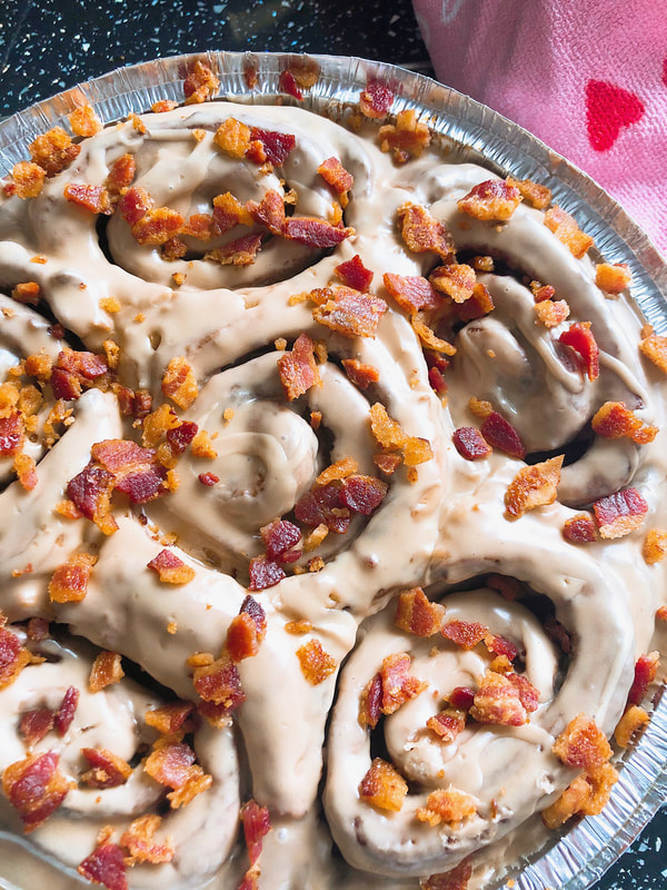 BREAKFAST MENU: A batch of our Maple Bacon Cinnamon Rolls which are classic cinnamon rolls coated in maple glaze and sprinkled with crispy salted bacon.